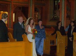 Frank, Suzanne, and Pat walk up the aisle